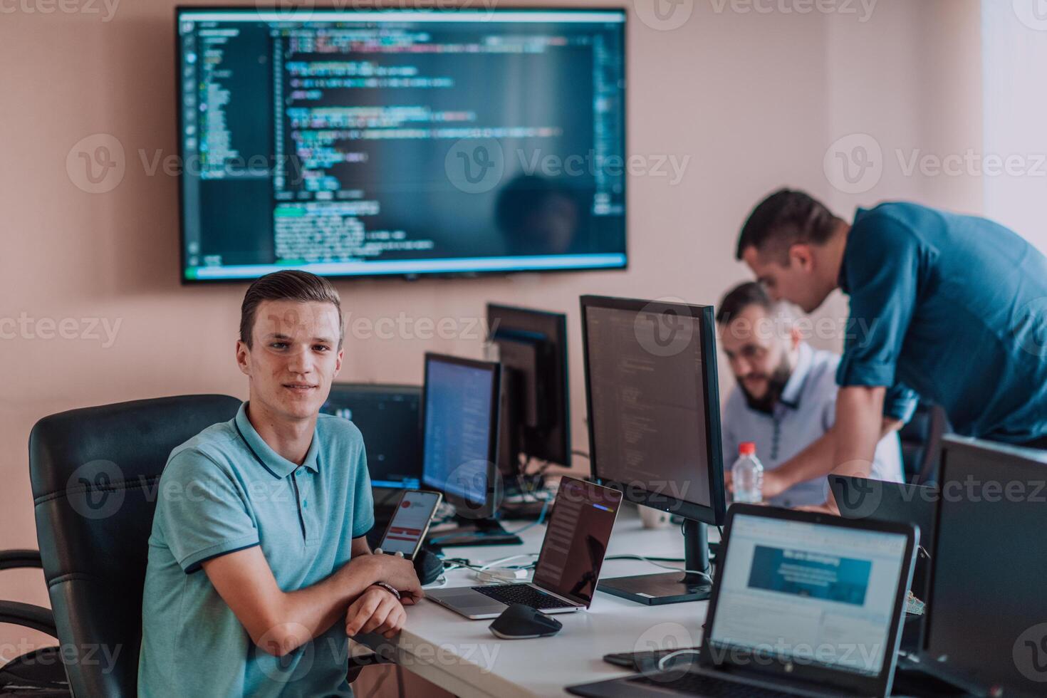 Programmers engrossed in deep collaboration, diligently working together to solve complex problems and develop innovative mobile applications with seamless functionality. photo