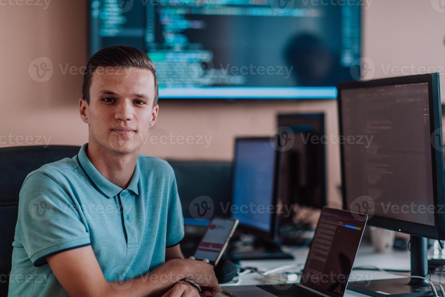 A programmer diligently testing smartphone applications while sitting in their office. photo