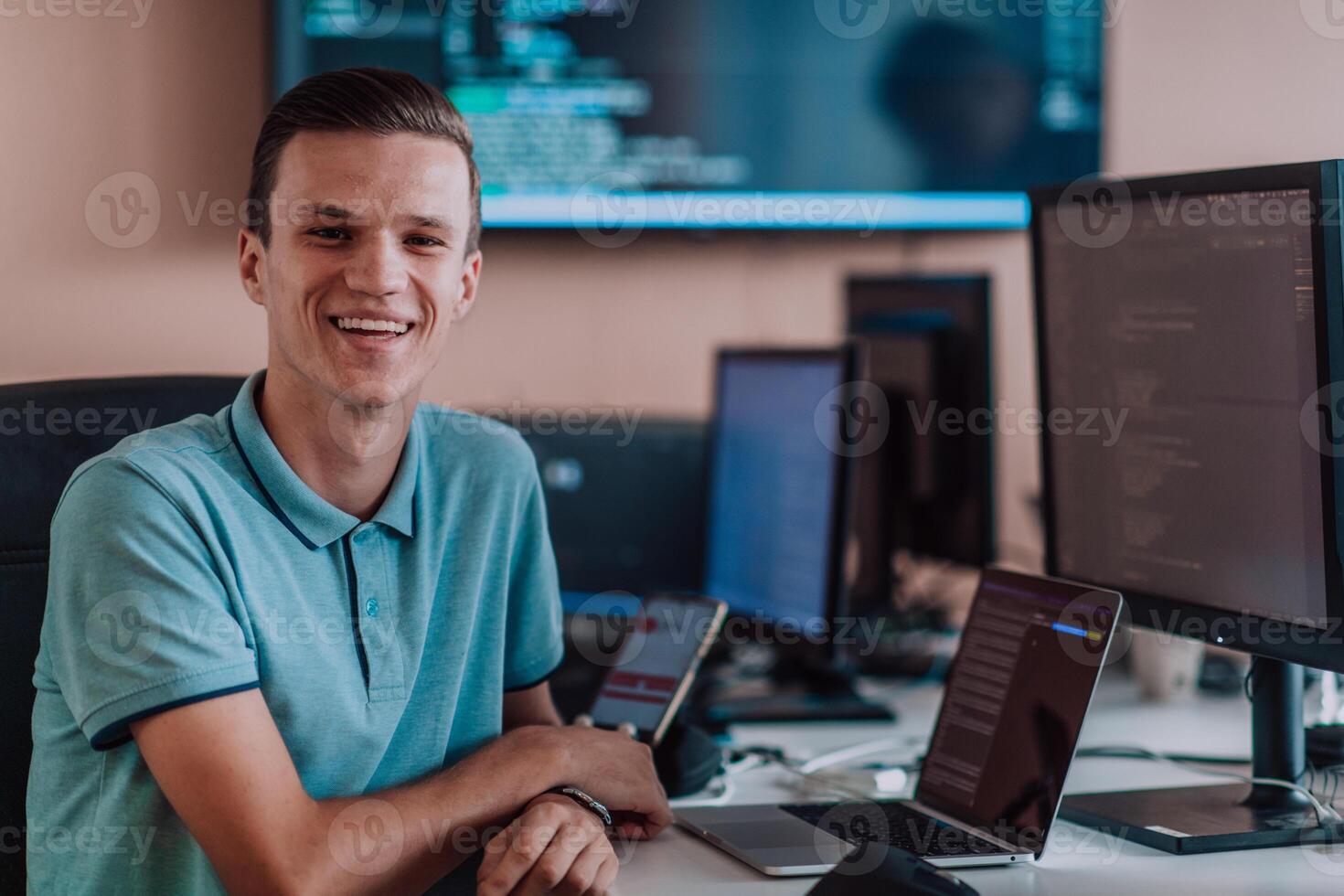 A programmer diligently testing smartphone applications while sitting in their office. photo