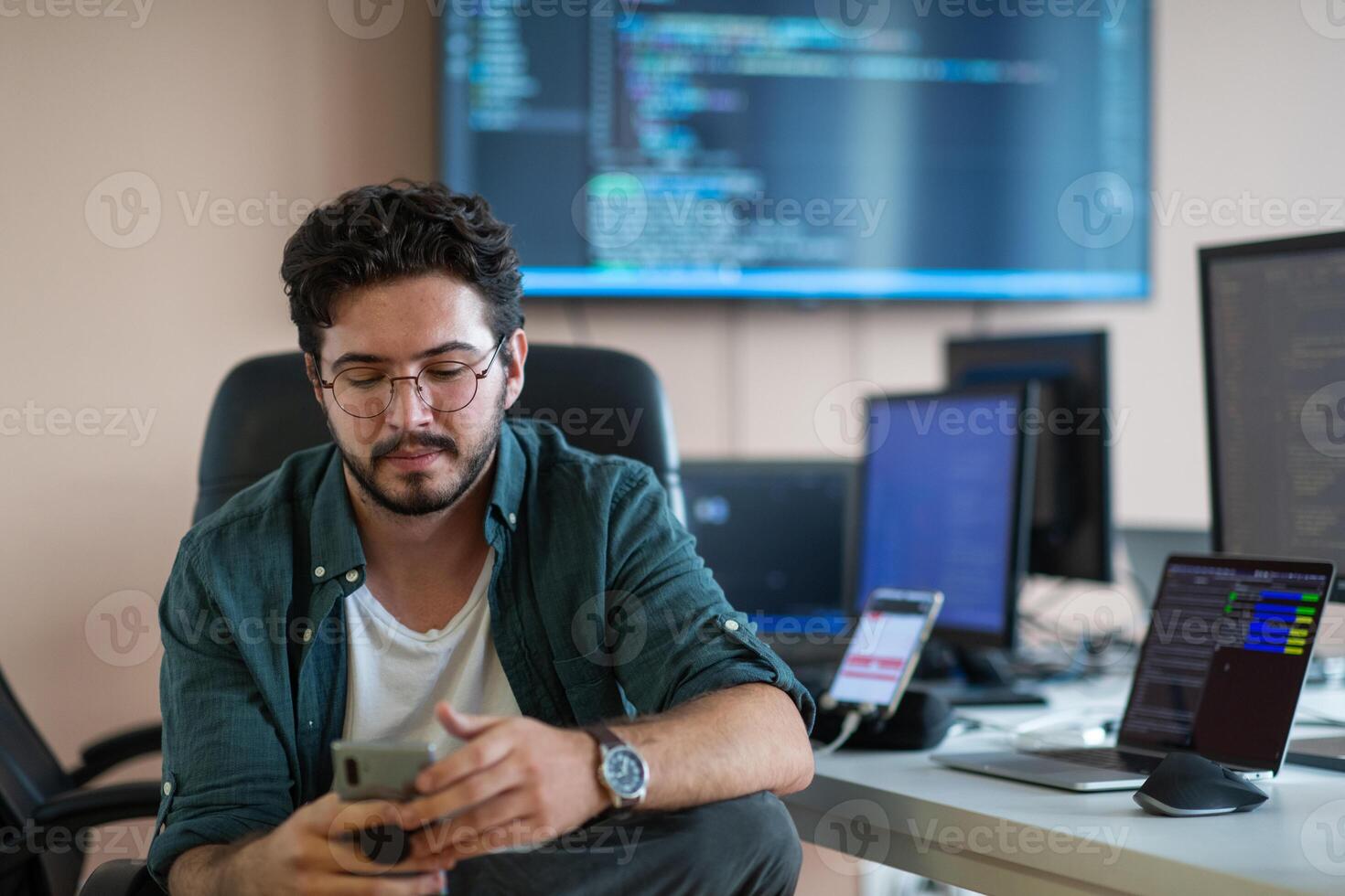 A programmer diligently testing smartphone applications photo
