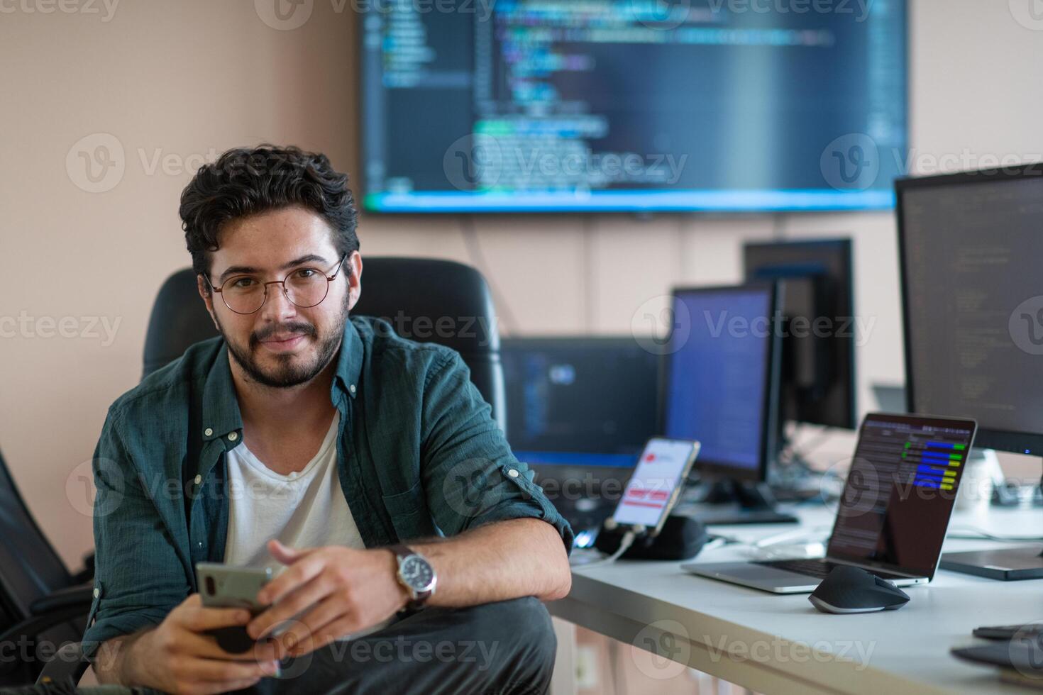 A programmer diligently testing smartphone applications photo