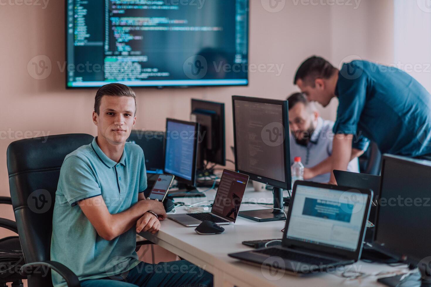 Programmers engrossed in deep collaboration, diligently working together to solve complex problems and develop innovative mobile applications with seamless functionality. photo