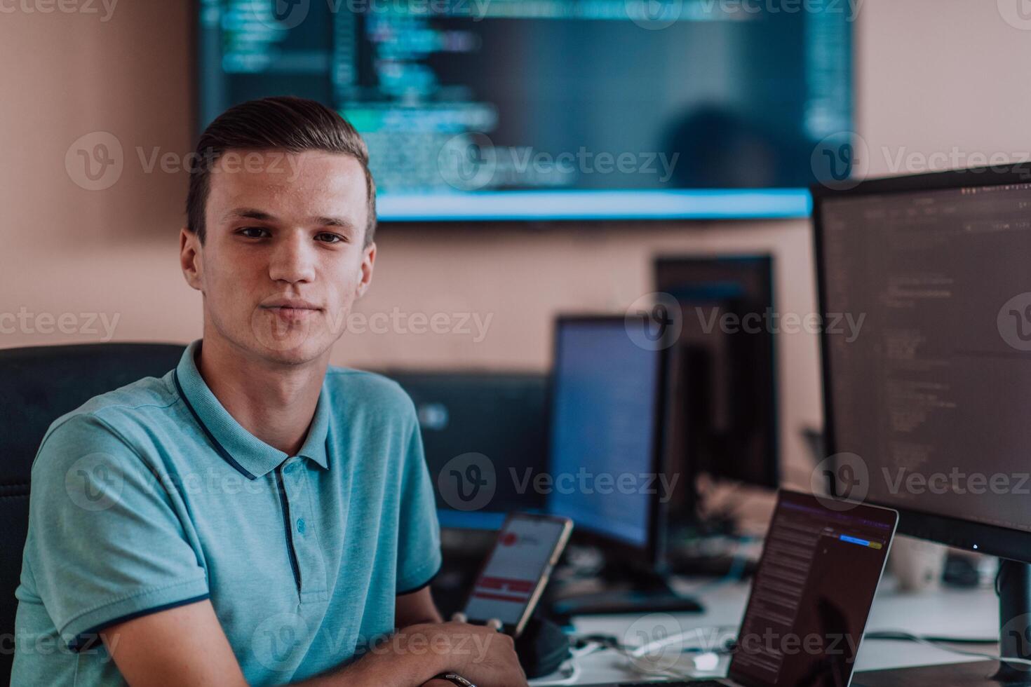 A programmer diligently testing smartphone applications while sitting in their office. photo