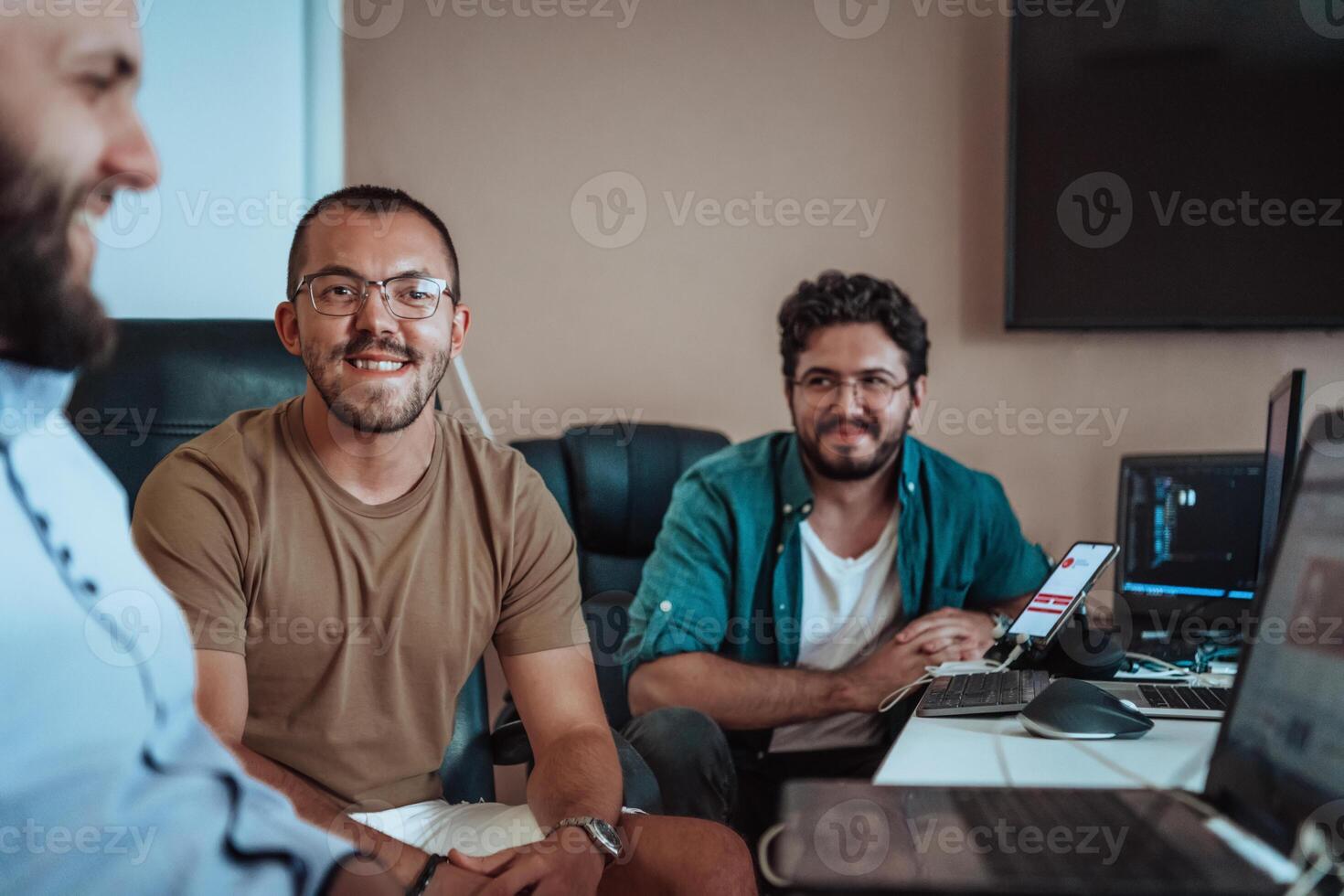 Programmers engrossed in deep collaboration, diligently working together to solve complex problems and develop innovative mobile applications with seamless functionality. photo