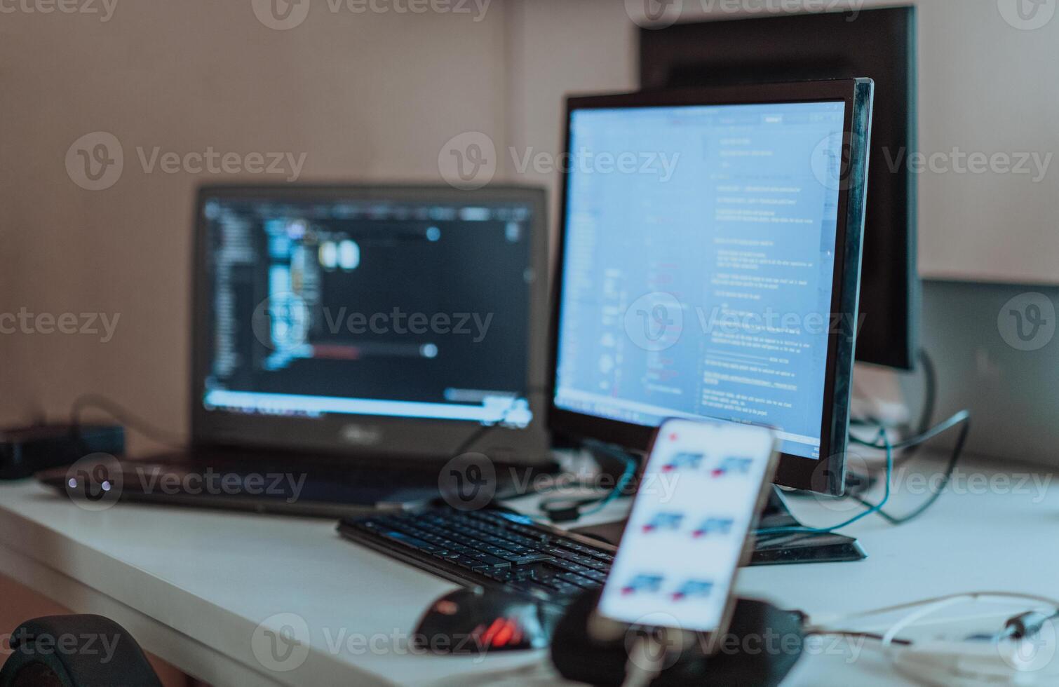 Computer screens running programming code in empty software developing agency office and computers parsing data algorithms in background. Neural network servers cloud computing in data room. photo