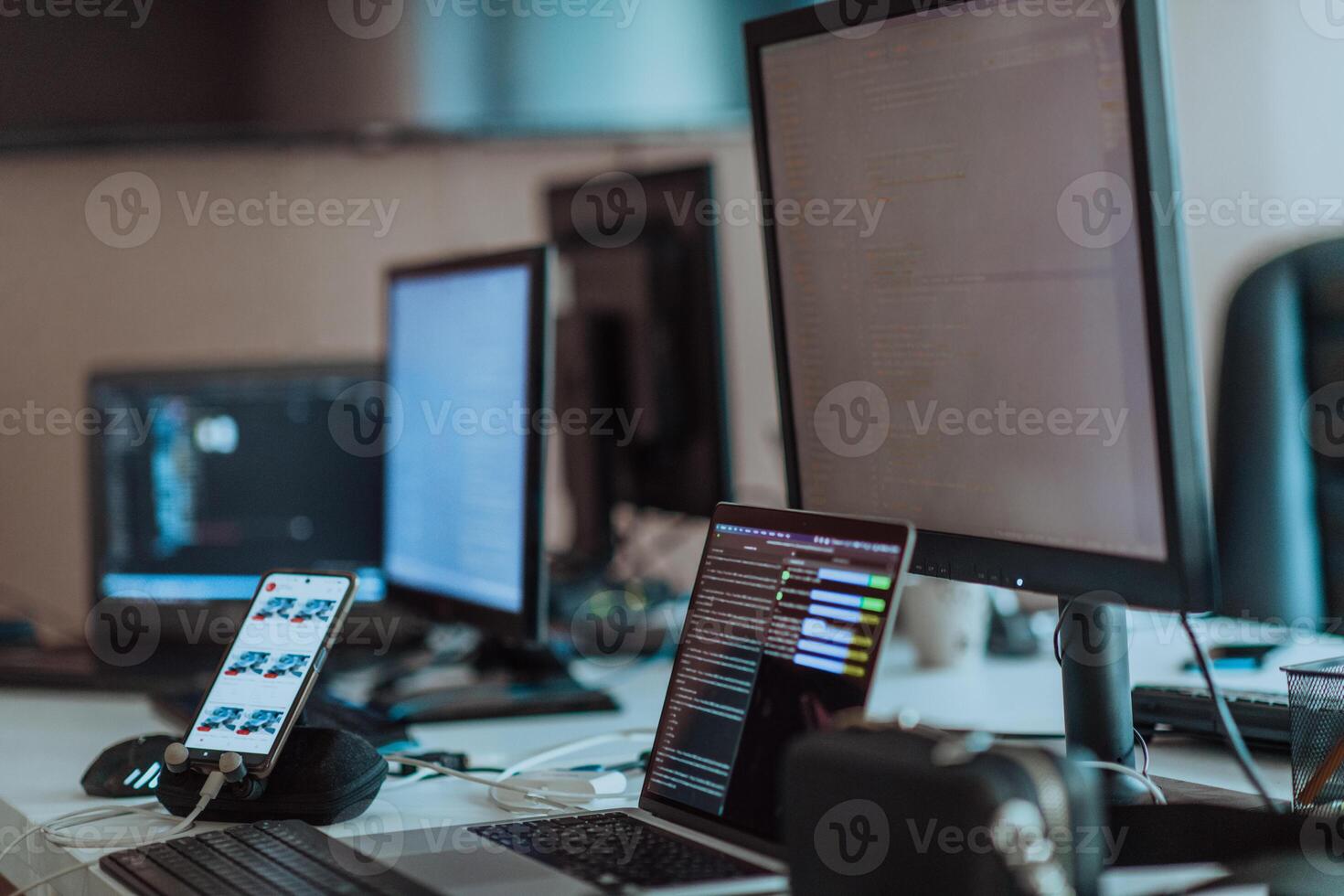 Computer screens running programming code in empty software developing agency office and computers parsing data algorithms in background. Neural network servers cloud computing in data room. photo