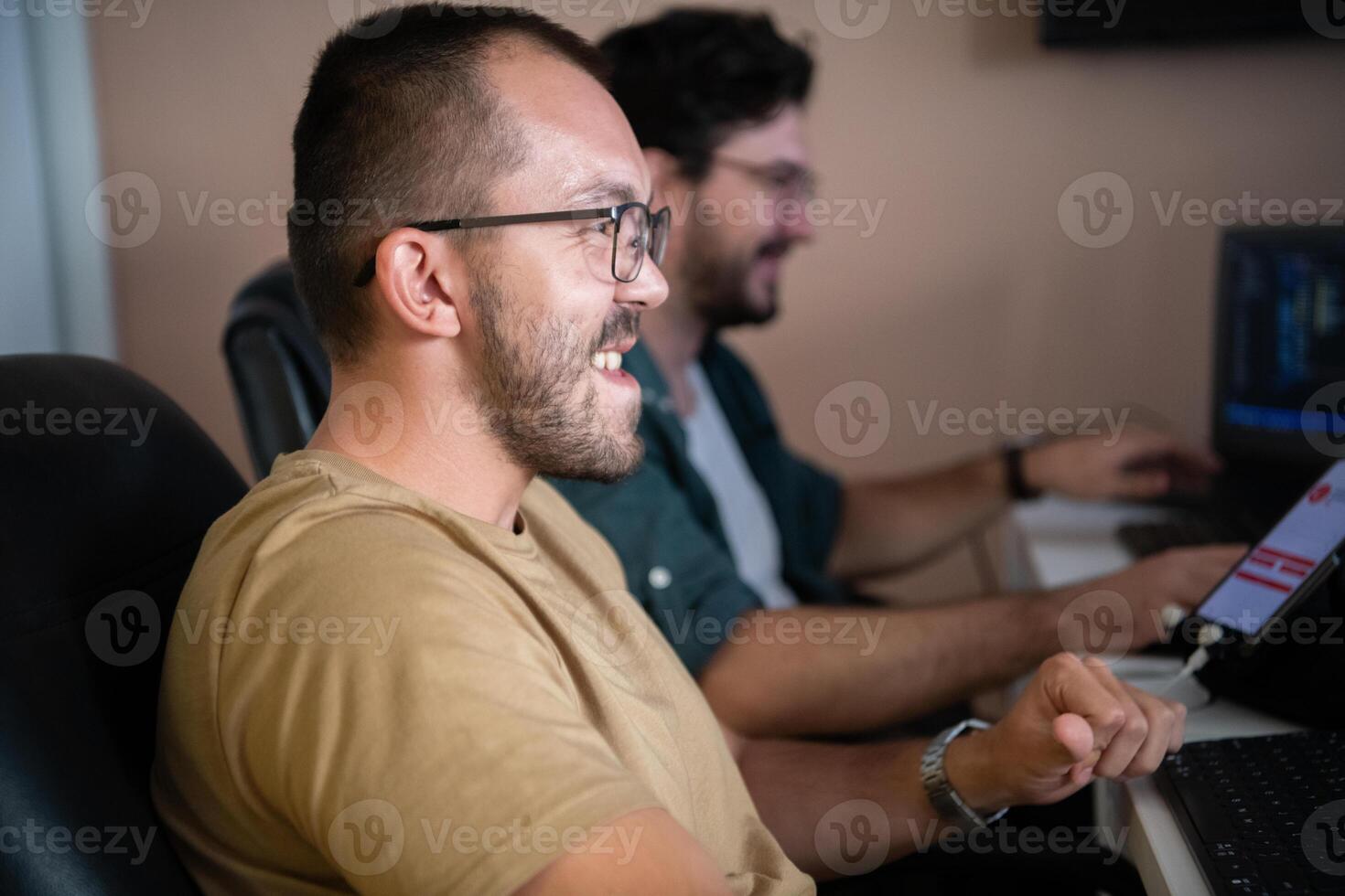 Programmers engrossed in deep collaboration, diligently working together to solve complex problems and develop innovative mobile applications with seamless functionality. photo