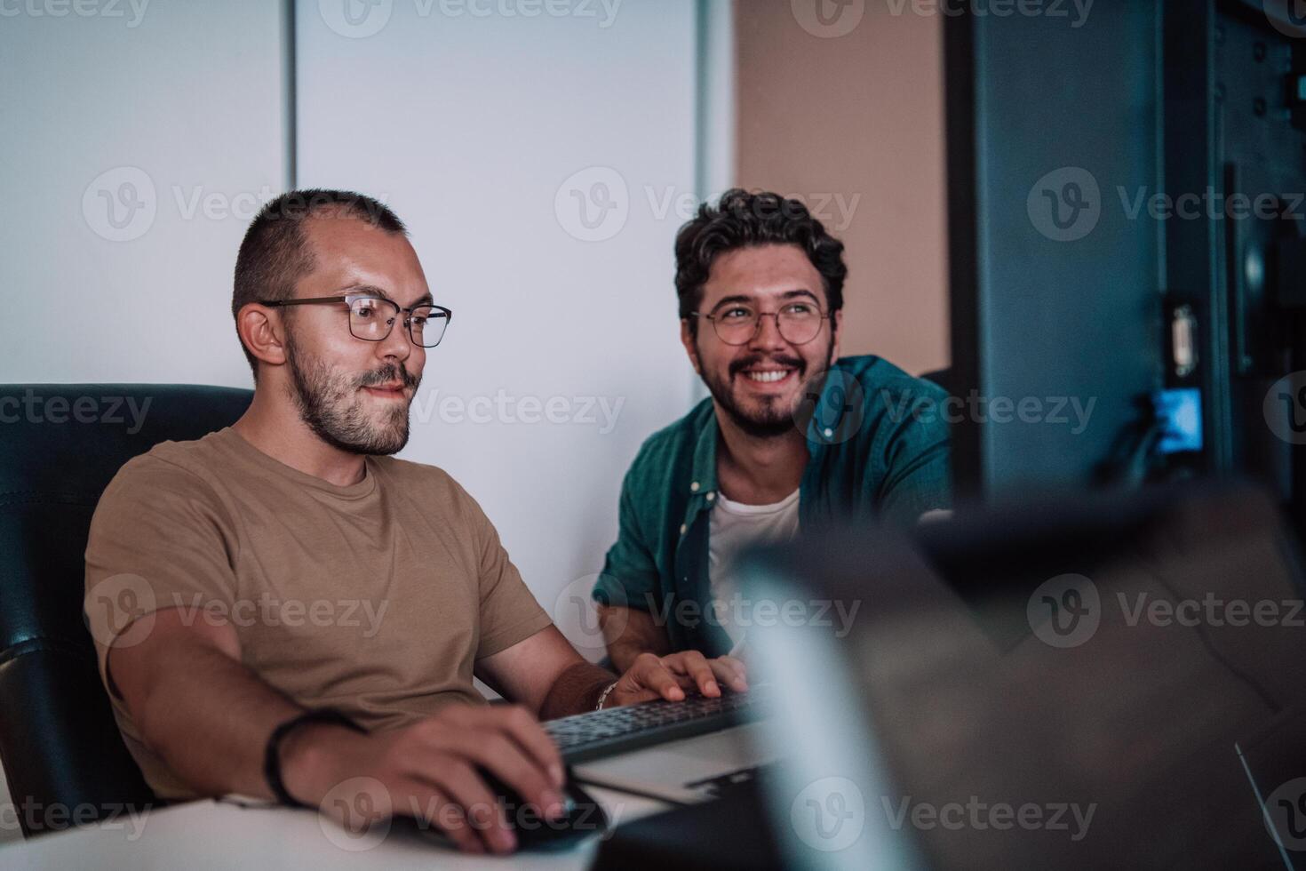 Programmers engrossed in deep collaboration, diligently working together to solve complex problems and develop innovative mobile applications with seamless functionality. photo