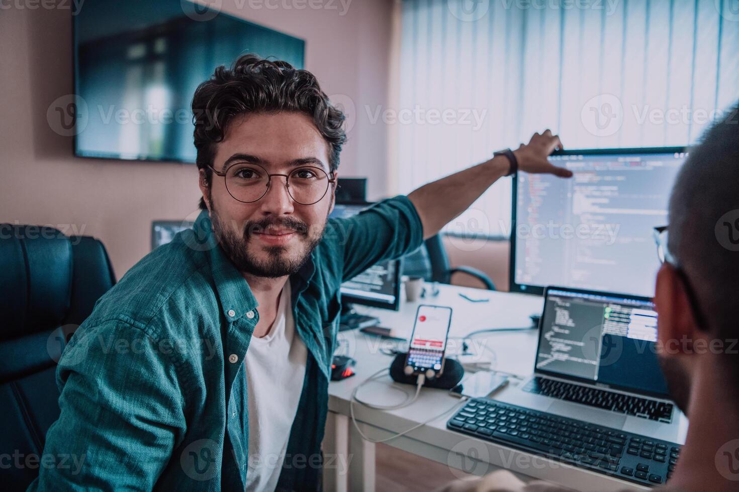 Programmers engrossed in deep collaboration, diligently working together to solve complex problems and develop innovative mobile applications with seamless functionality. photo