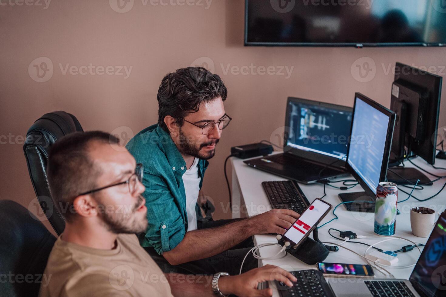 Programmers engrossed in deep collaboration, diligently working together to solve complex problems and develop innovative mobile applications with seamless functionality. photo
