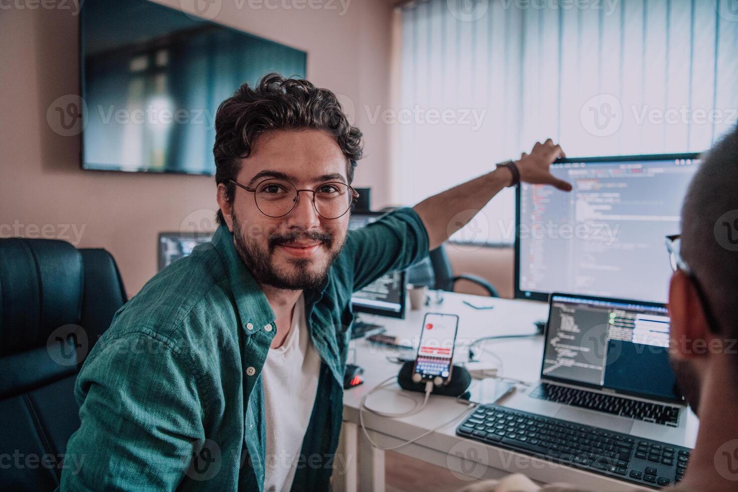 Programmers engrossed in deep collaboration, diligently working together to solve complex problems and develop innovative mobile applications with seamless functionality. photo
