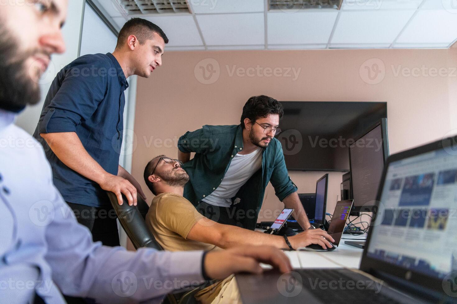 Collaborative Minds. A Team of Programmers Tackling Challenges Together in the Office. photo