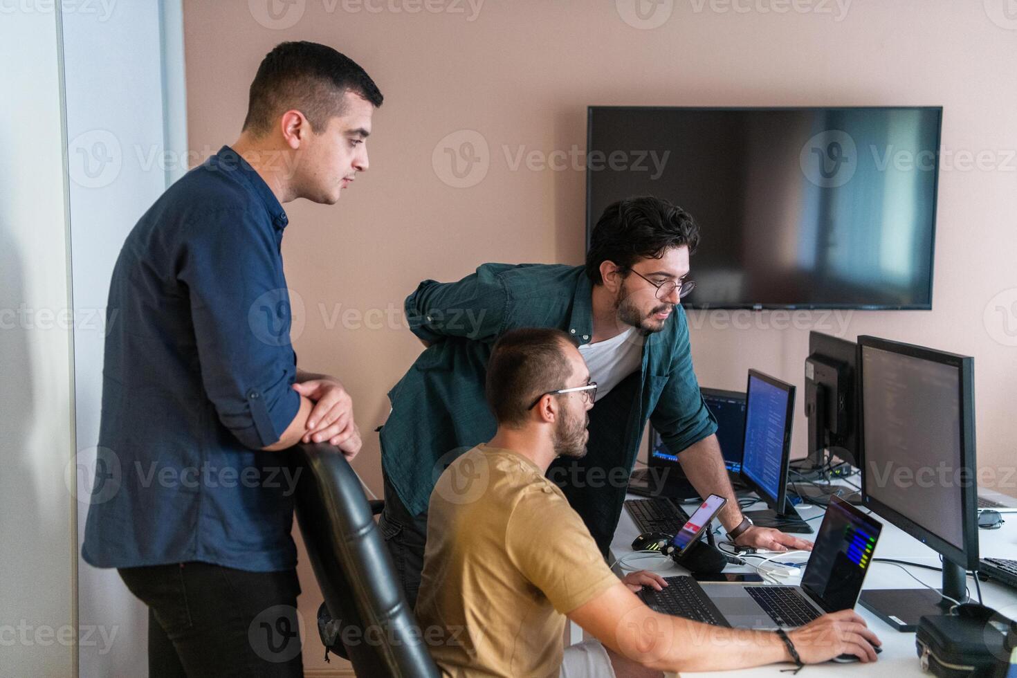 Collaborative Minds. A Team of Programmers Tackling Challenges Together in the Office. photo