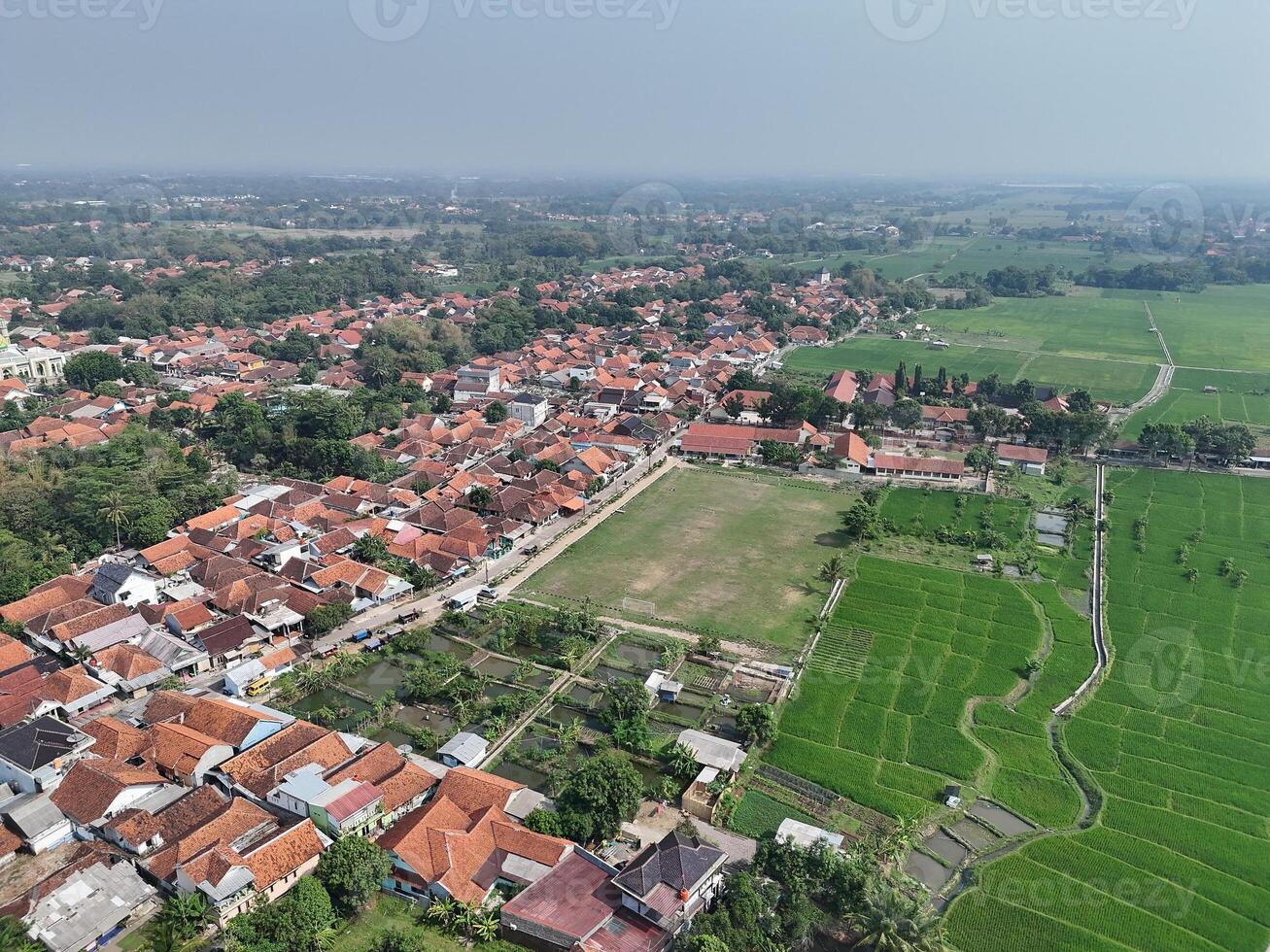 aerial view of a village in the countryside. rice fields around the village. photo