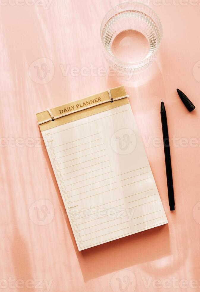 Flat lay minimalist daily planner with a simple design, featuring checkboxes and lines for tasks photo