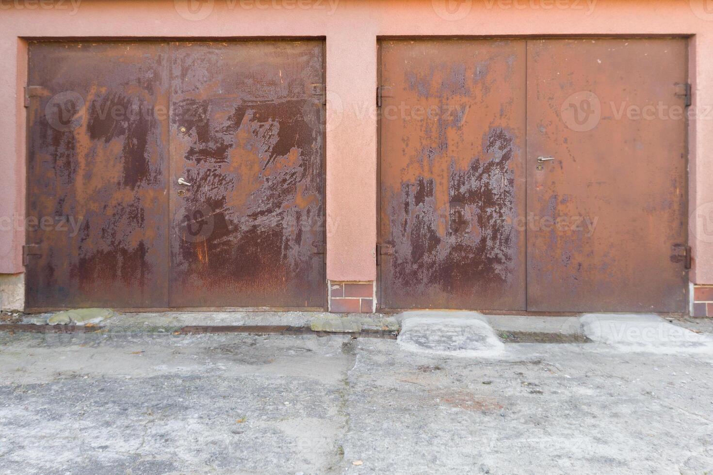 Two rusted metal doors with weathered surface photo