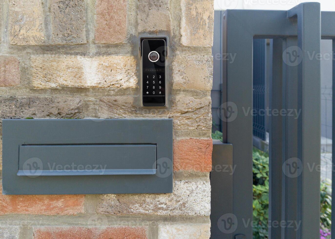 Modern mailbox and intercom on brick wall photo