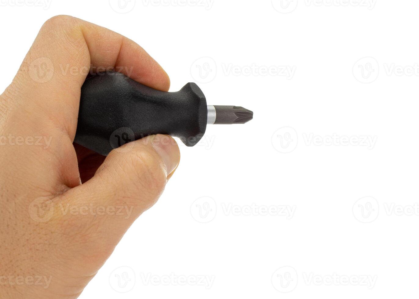 Hand holding black handle screwdriver for precision work photo