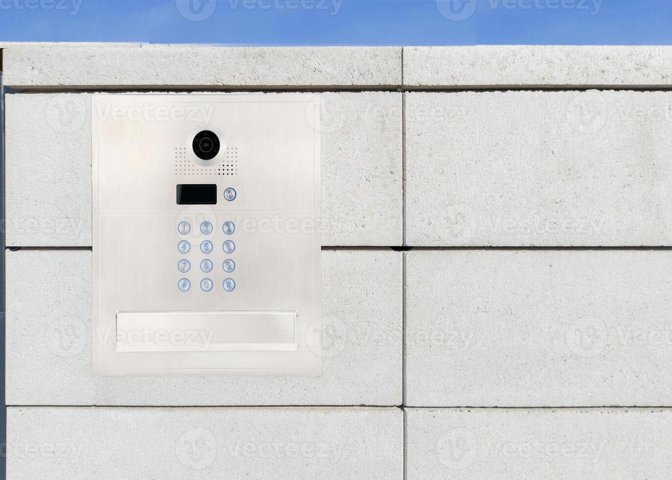 Security keypad and camera on concrete wall photo