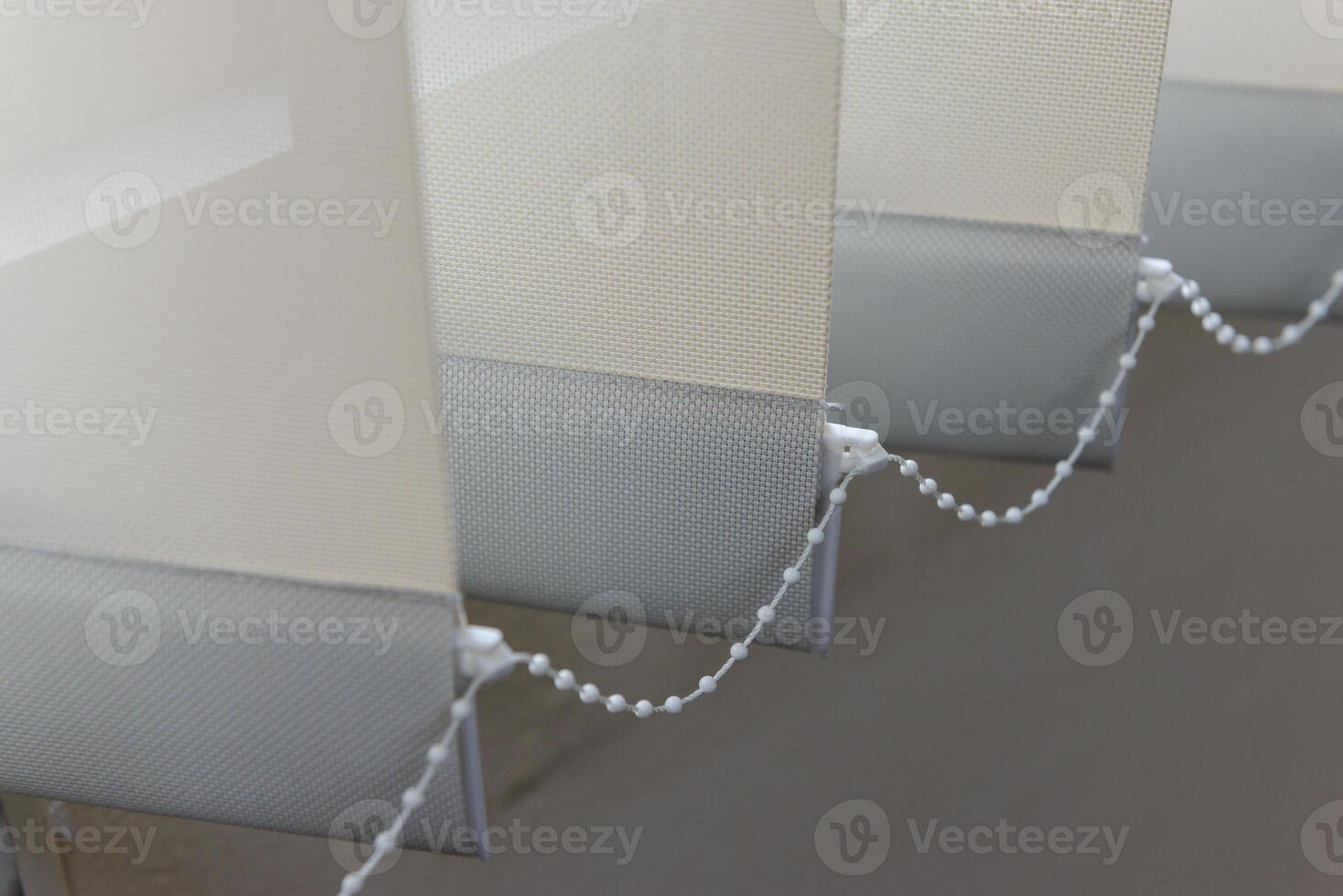 Modern vertical fabric blinds on the window in the office photo