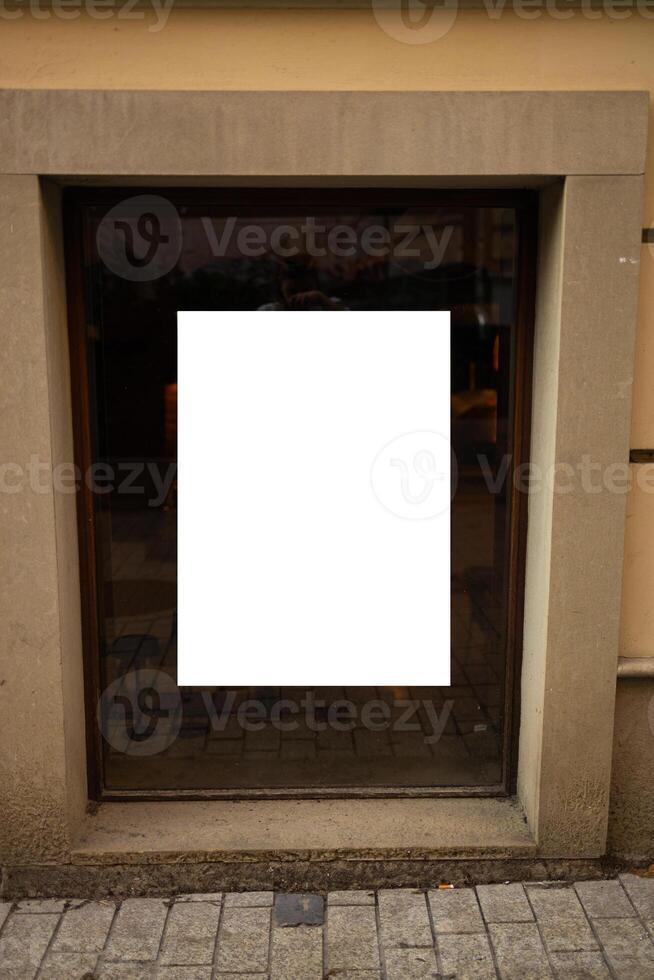 White paper poster mockup displayed outside the building restaurant. Marketing and business concept. photo