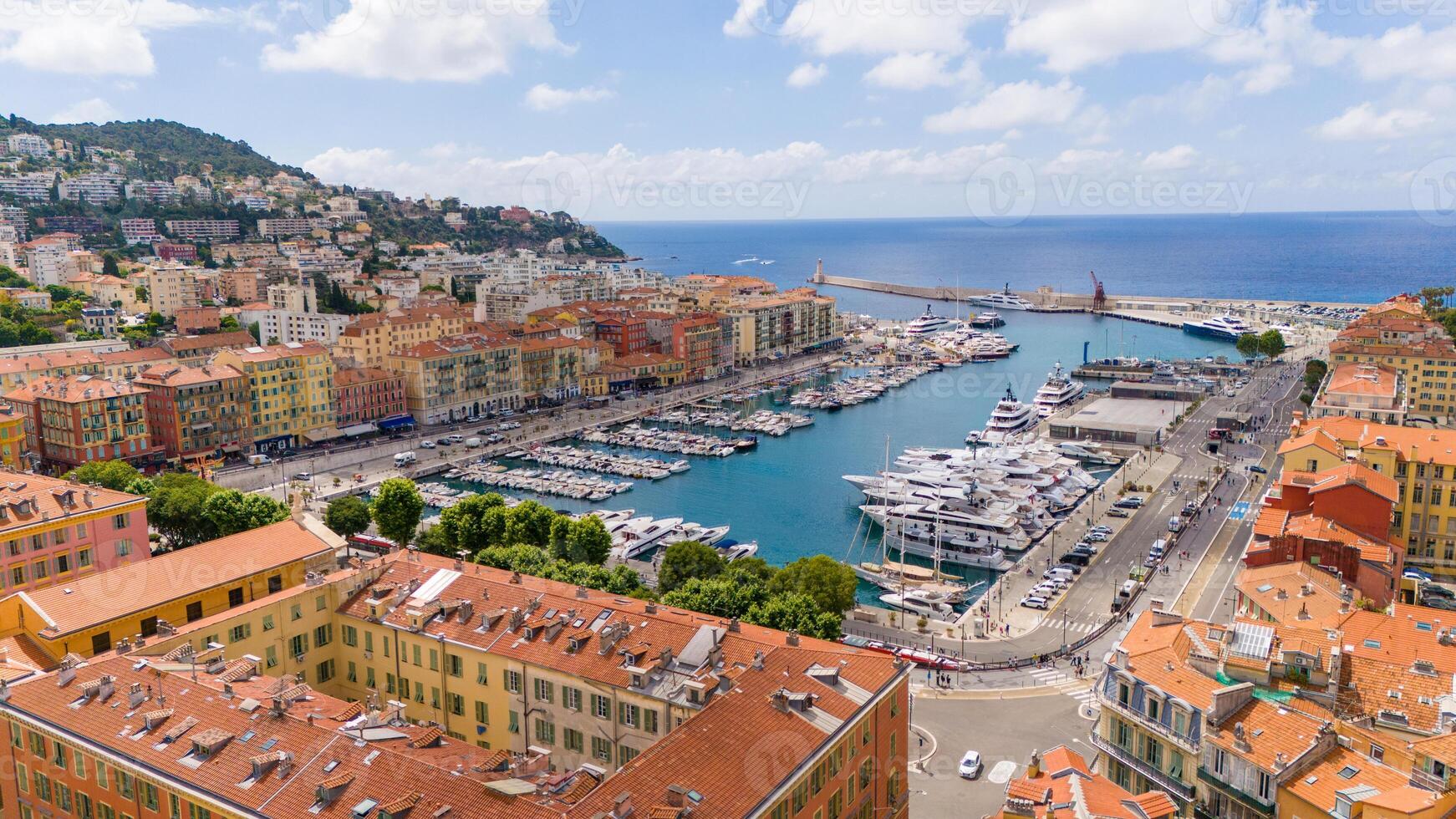 Aerial view of Nice, France, showcasing the vibrant Port of Nice, with colorful buildings, yachts, and a scenic Mediterranean backdrop. The city blends historic charm with coastal beauty photo