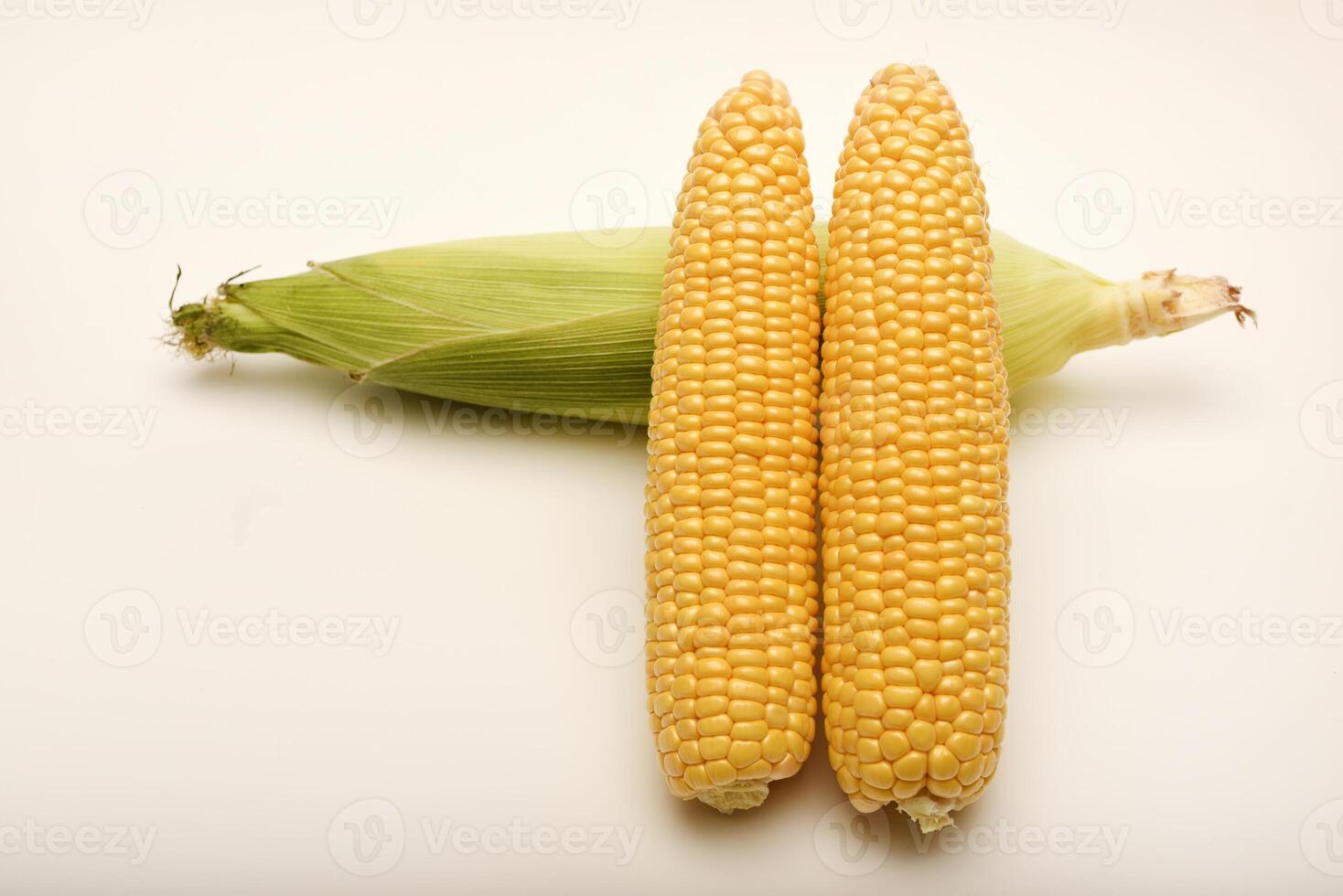 Three ears of corn on a white background. A printed cob. Ripe corn. photo