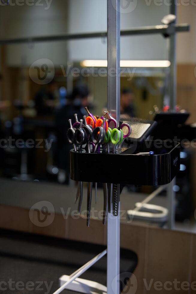 A collection of hair cutting scissors displayed in a barbershop setting photo