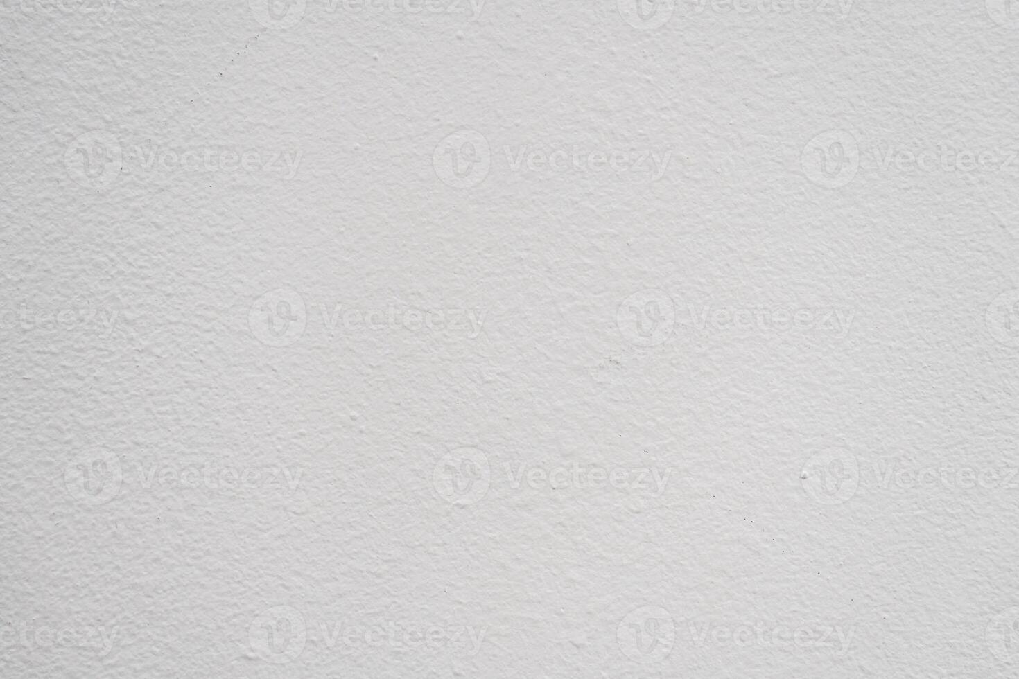 Plain white wall texture with subtle variations in shade, ideal for backgrounds in various design projects photo