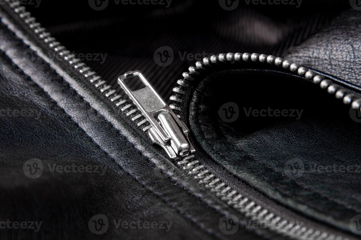Iron zipper on a black leather jacket, needlework concept. photo
