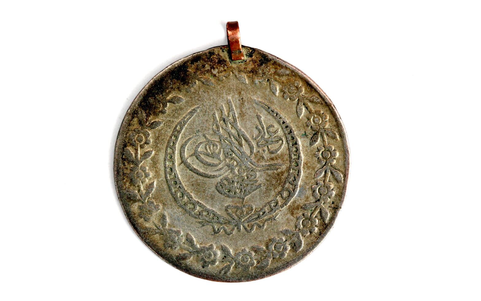 picture of a close up of an ancient ottoman coin photo