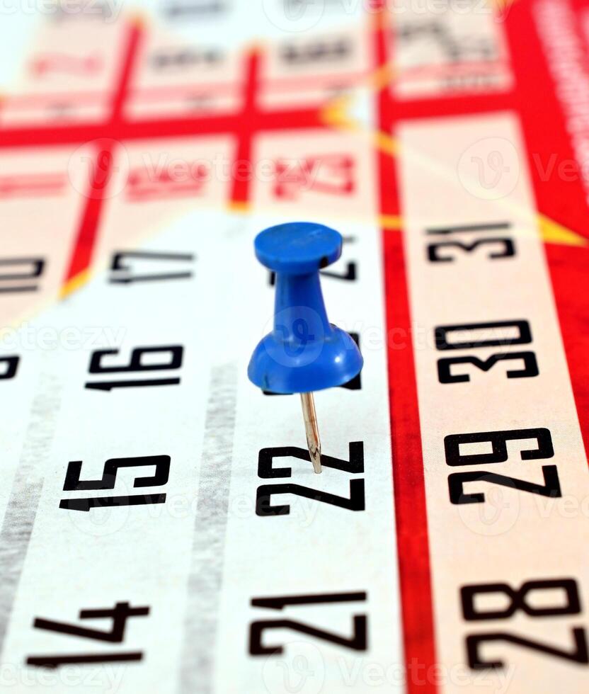 pushpin on a calendar date, reminder and time concept photo