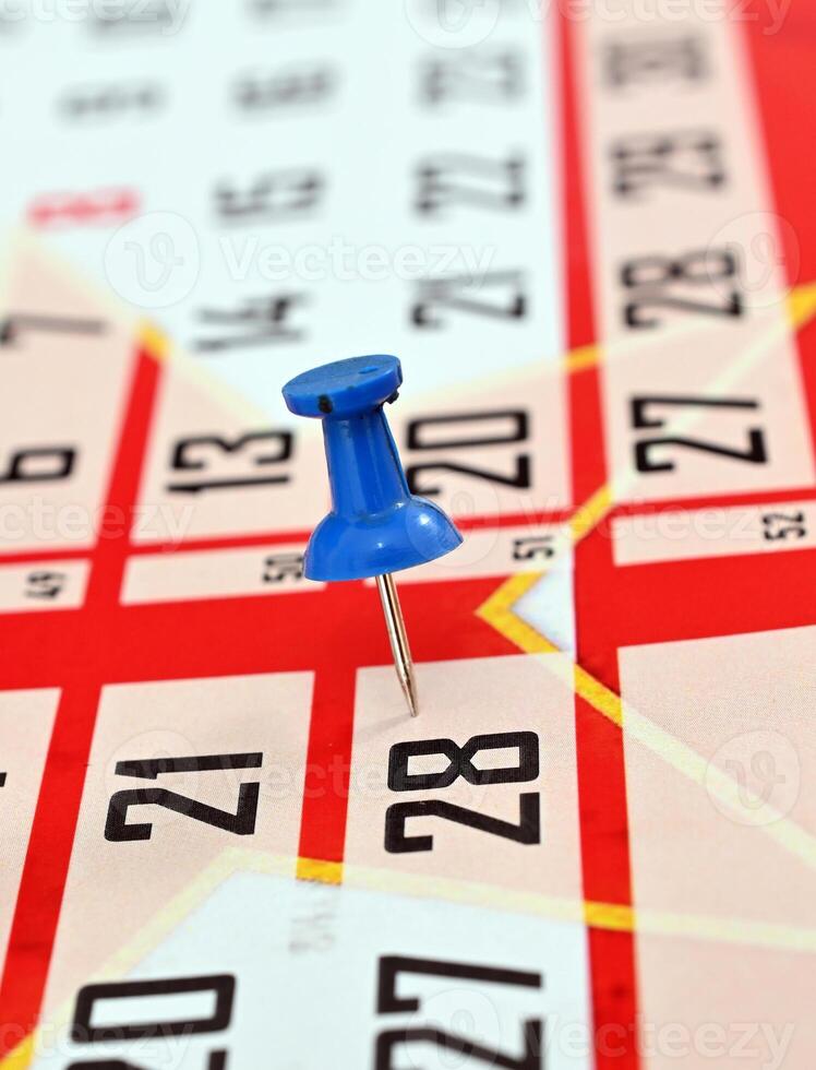 pushpin on a calendar date, reminder and time concept photo