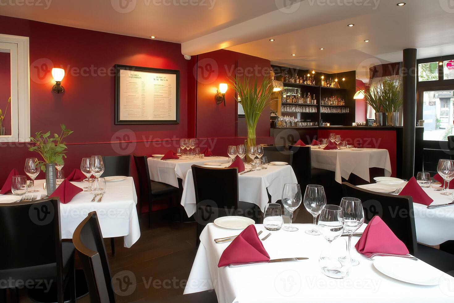 Cozy restaurant corner with elegant dark red decor and soft lighting creating a sophisticated dining ambiance photo