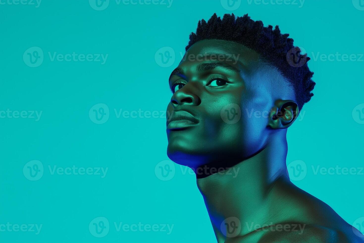 Athletic man showcasing focused expression and muscular physique in sportswear against gradient studio backdrop photo