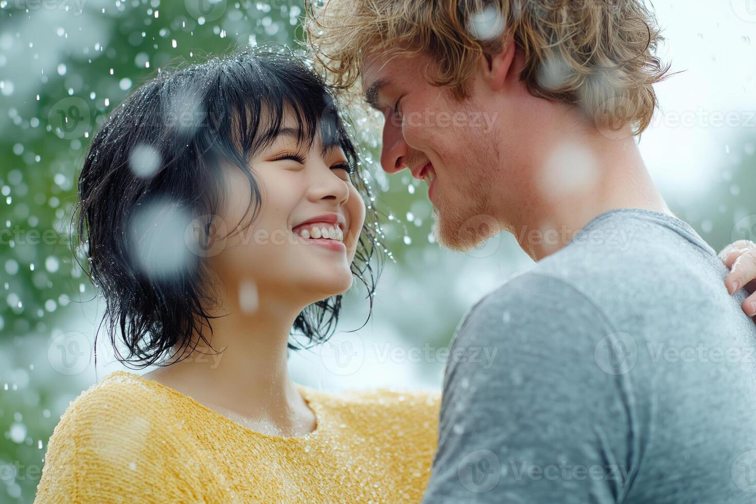 Happy couple dancing together in the rain during gentle midday light photo