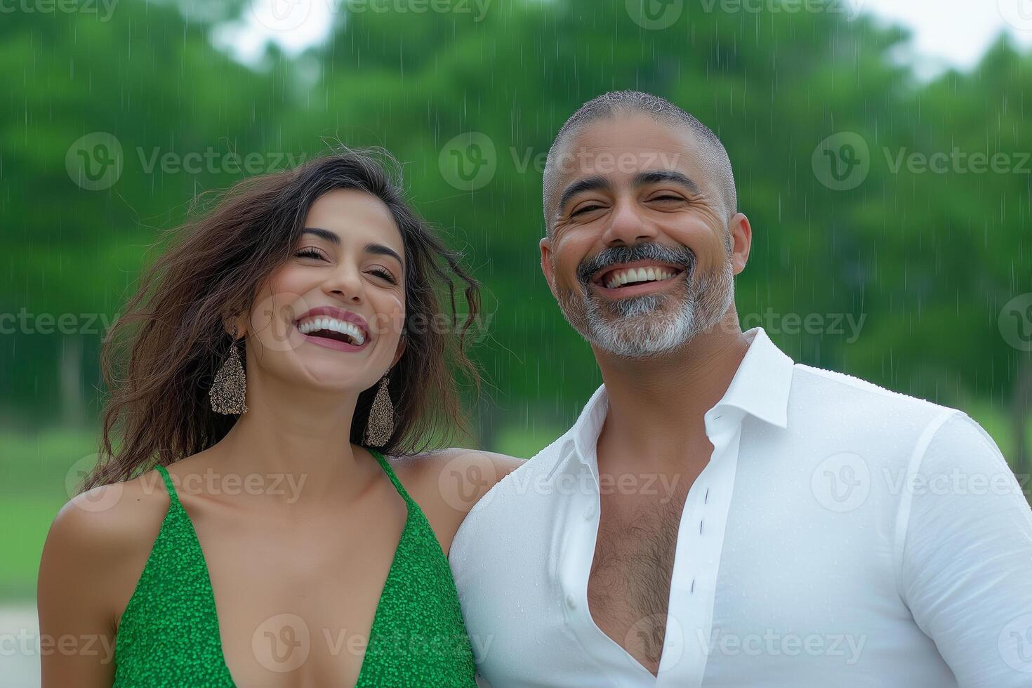 Joyful Hispanic couple dancing in light rain during an afternoon, illuminated by soft sunlight photo