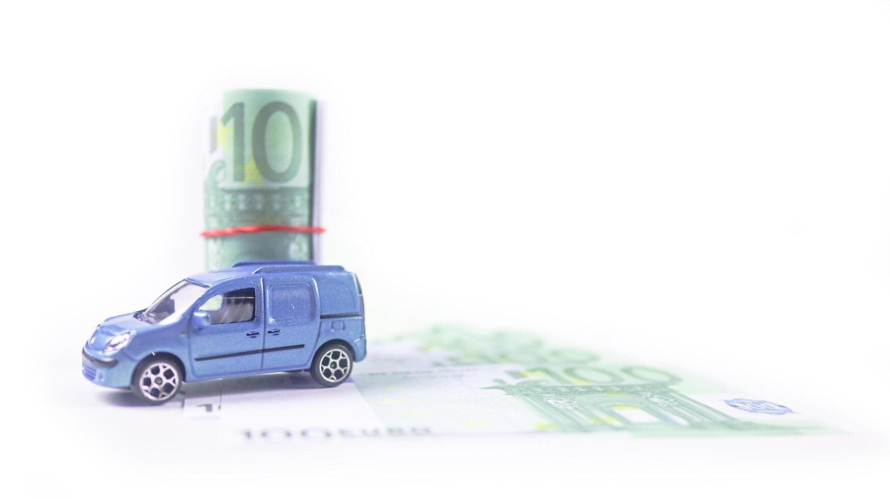 Model car with euro banknotes on white background concept of saving for buying car, car loan and car insurance. photo