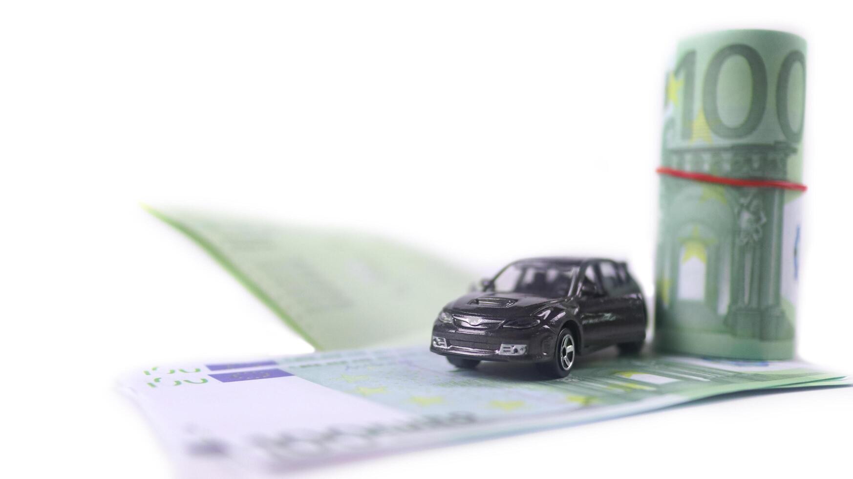 Model car with euro banknotes on white background concept of saving for buying car, car loan and car insurance. photo