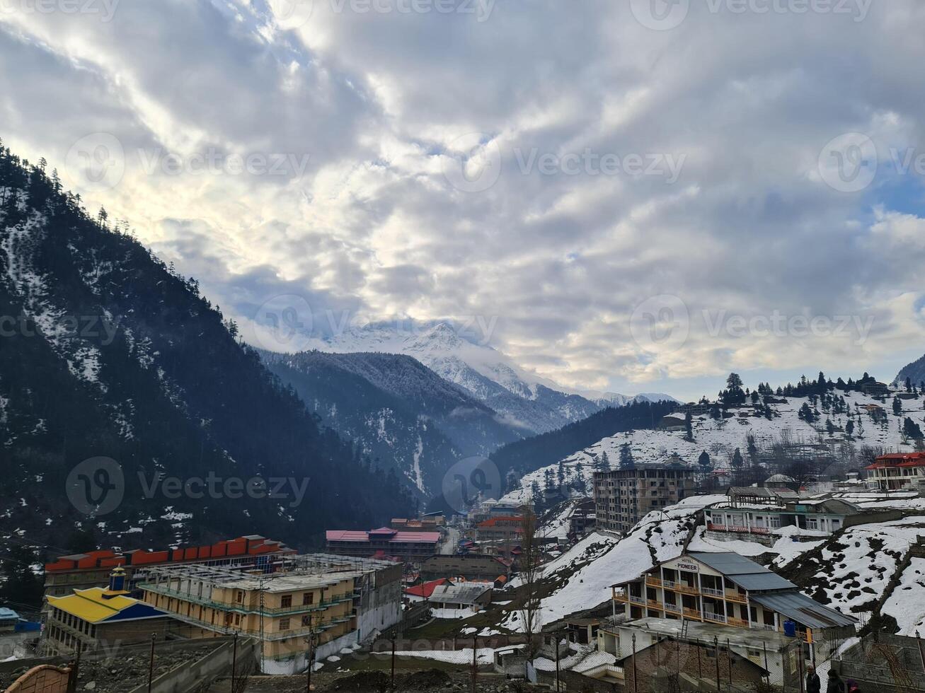 A view of a snowy mountain town with buildings and snow photo