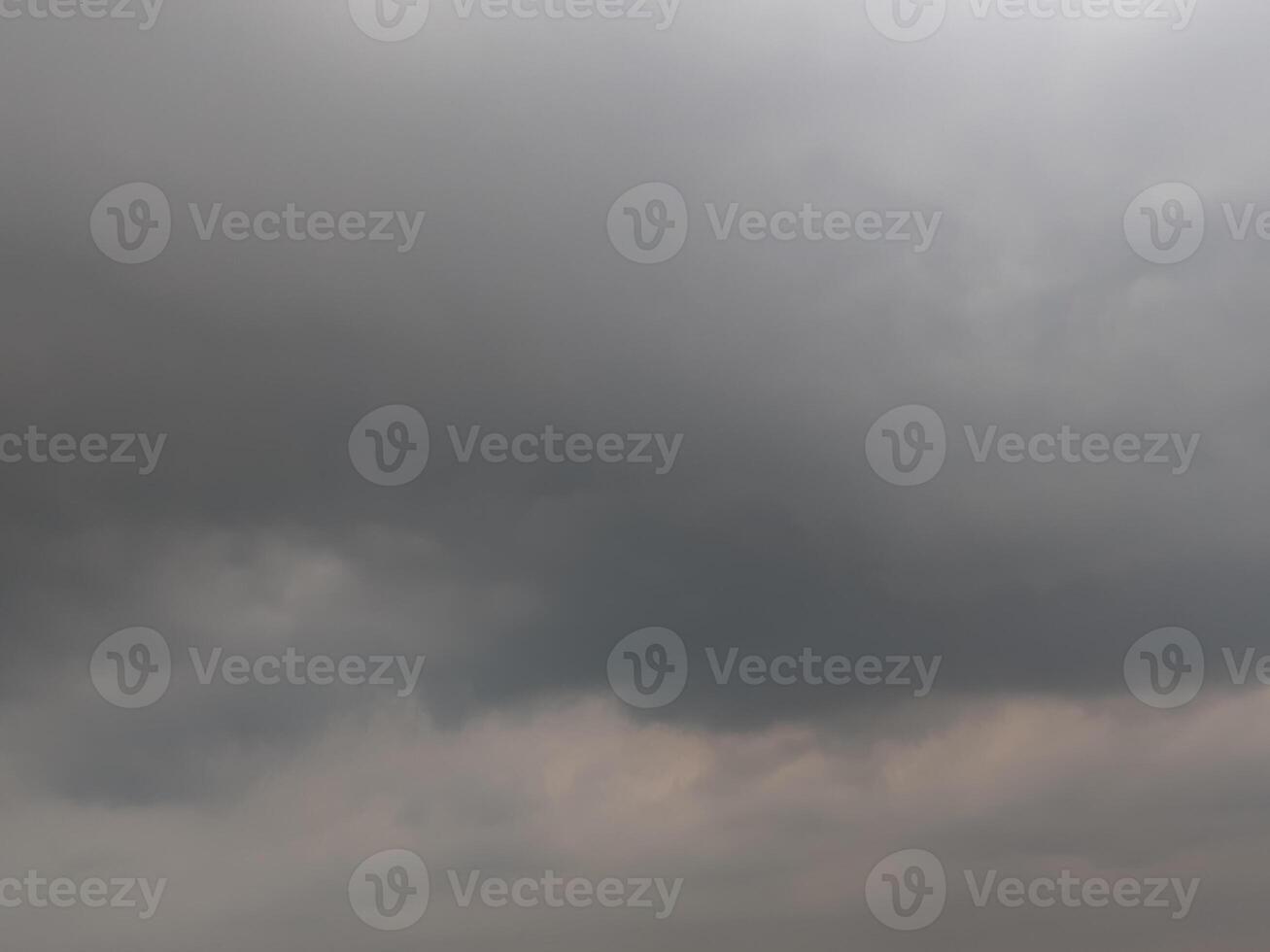 A moody, atmospheric sky filled with heavy, gray clouds. photo