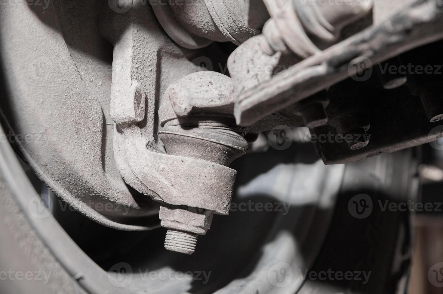 Close-up view from under the car. Dirty suspension of an off-road vehicle. Transmission components photo