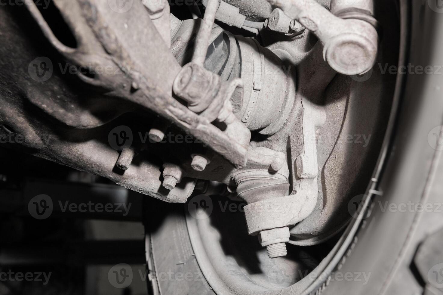Close-up view from under the car. Dirty suspension of an off-road vehicle. Transmission components photo