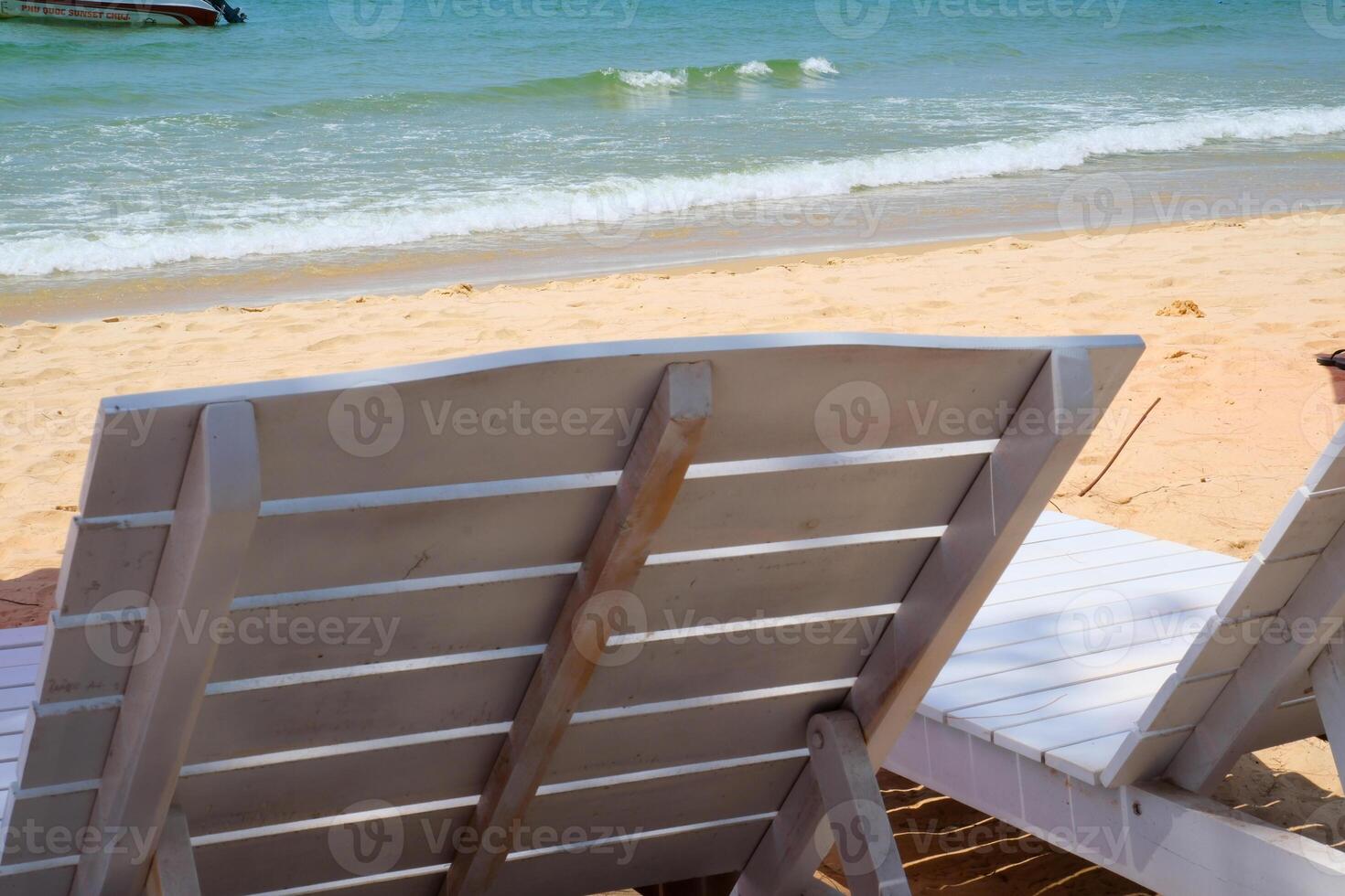 white sun loungers on the beach Stylish white sun loungers by pool on sunny day. Selection of quality summer sun loungers photo