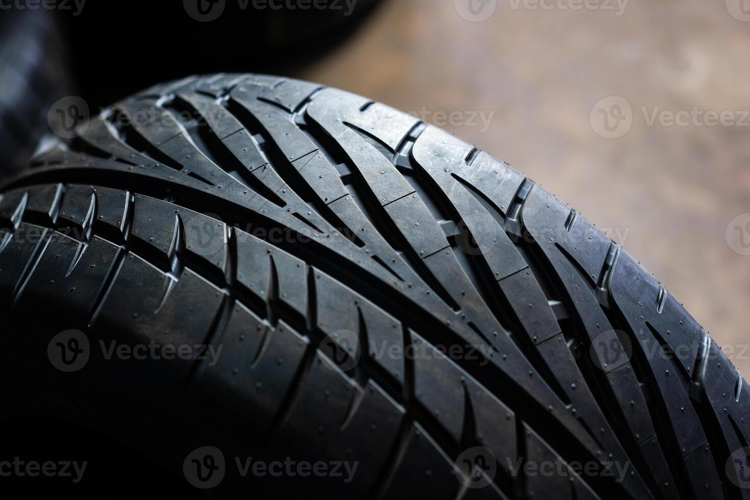 Closeup racing pattern tires.New tires in the garage with customer serviceCar tire close up. Tyre background. Car tire background. photo