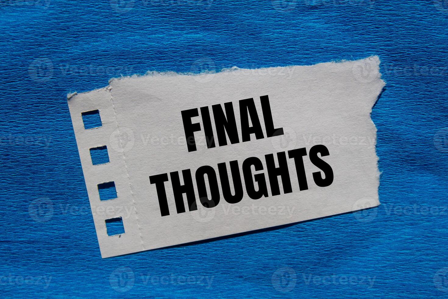 Final thoughts message written on ripped torn paper piece with blue background. Conceptual final thoughts symbol. Copy space. photo