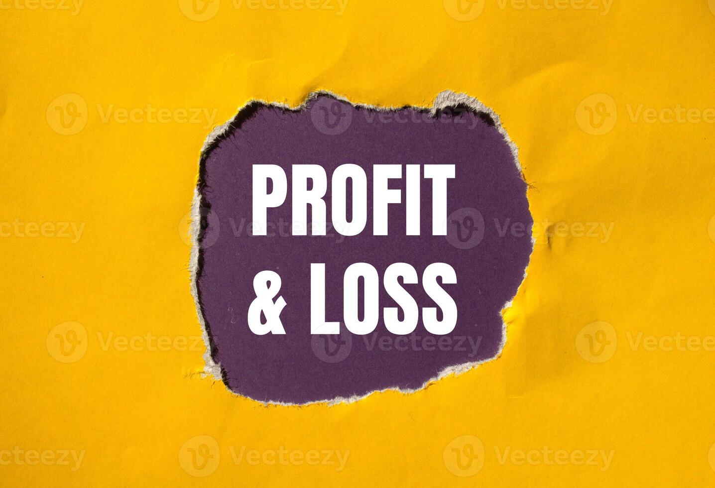 Profit and loss message written on ripped torn yellow paper with purple background. Conceptual profit and loss symbol. Copy space. photo