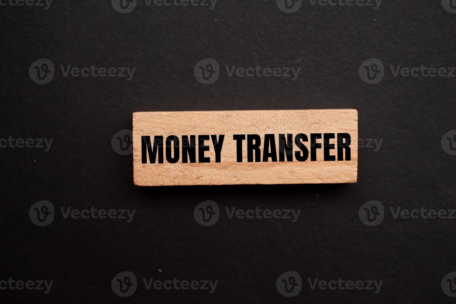 Money transfer message written on wooden block with black background. Conceptual money transfer symbol. Copy space. photo