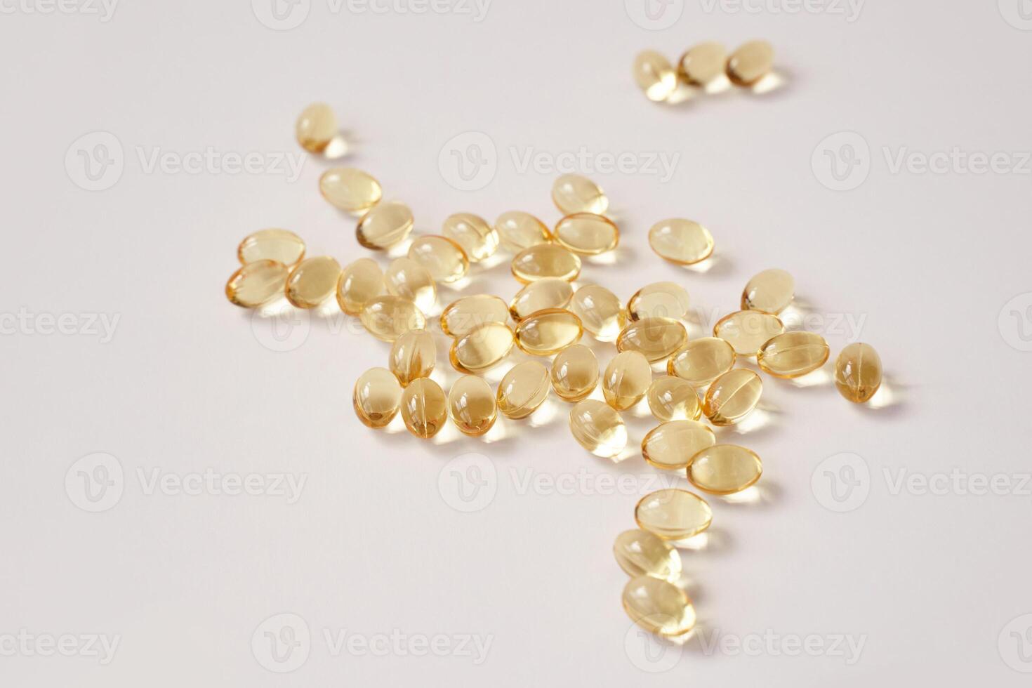 Scattered transparent capsules on white background highlighting health and wellness supplements photo