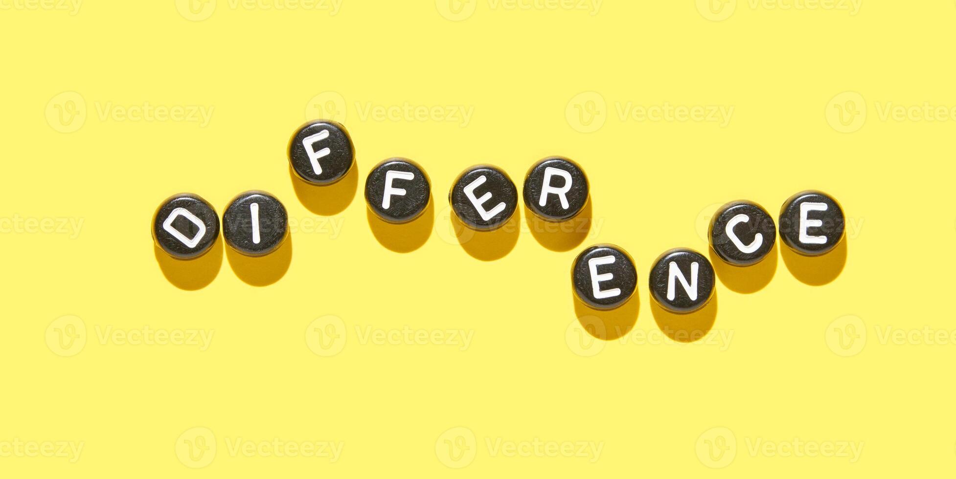 Letters spelling out difference on bright yellow background highlighting distinctive and unique concepts. photo